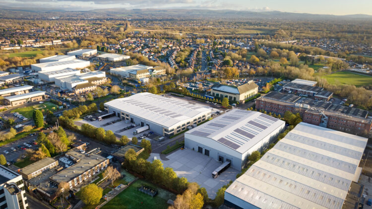An industrial complex consisting of two separate units. Green landscape surrounds the logistics facility, with lorries loading and unloading.