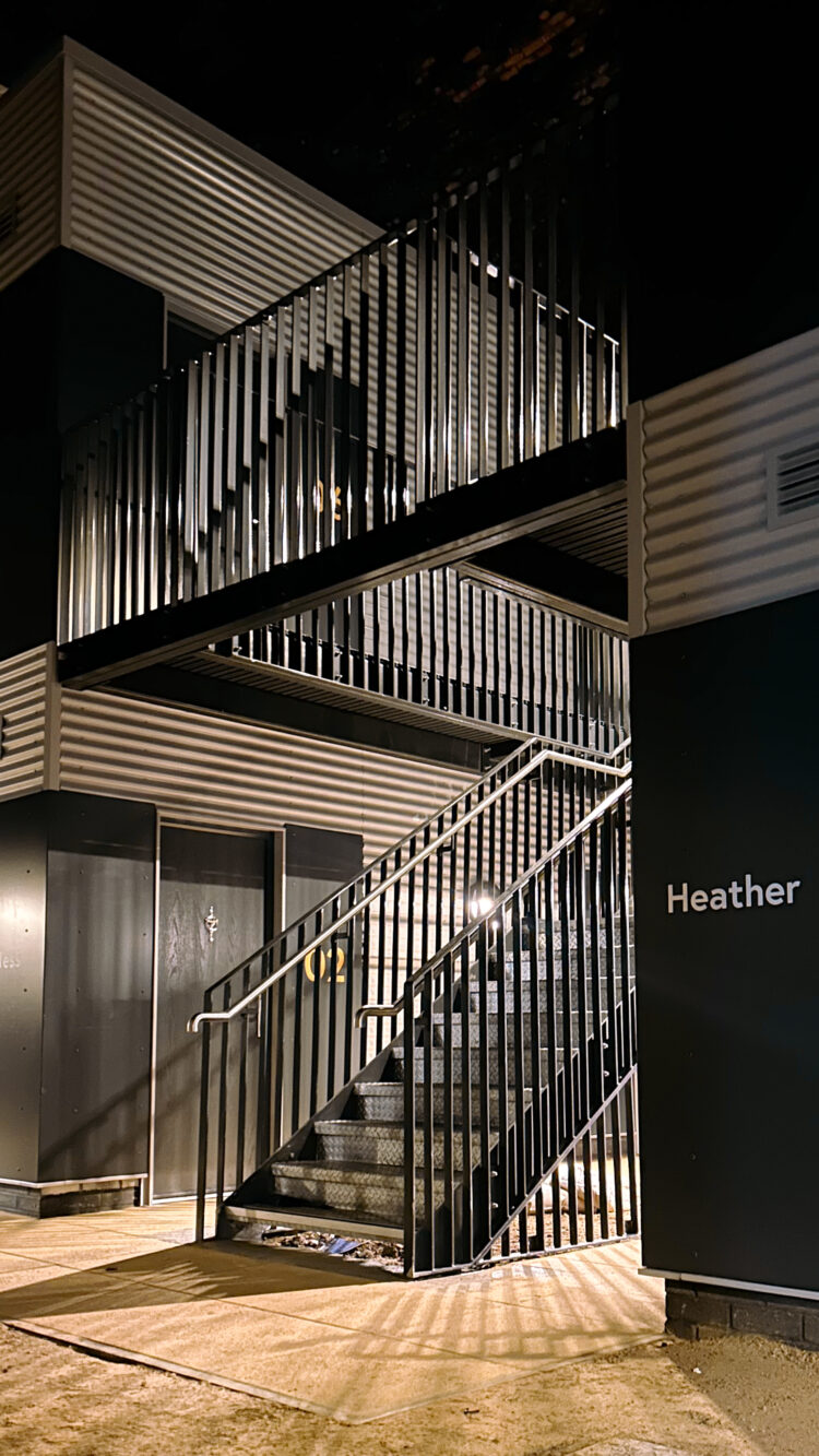 View of Embassy Village - a development for those rough sleeping - showing the stairs leading up to the first story homes.